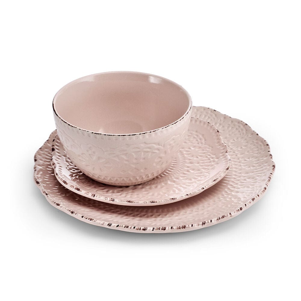 Close-up of Chateau Pink dinnerware with scalloped edges and lace pattern