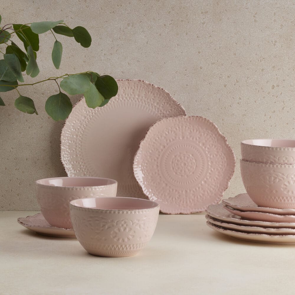 Close-up of Chateau Pink dinnerware with scalloped edges and lace pattern
