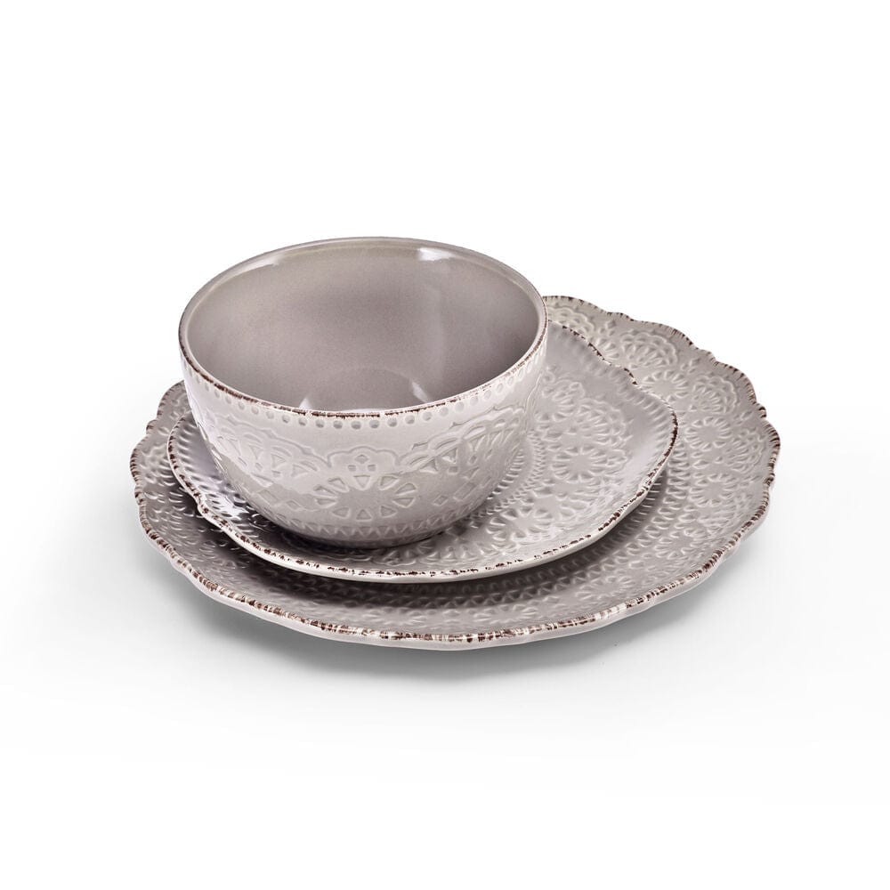 Elegant dinnerware with intricate lace-inspired design on a stylish table setting