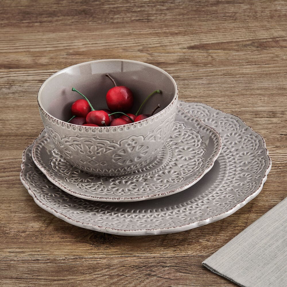 Elegant dinnerware with intricate lace-inspired design on a stylish table setting