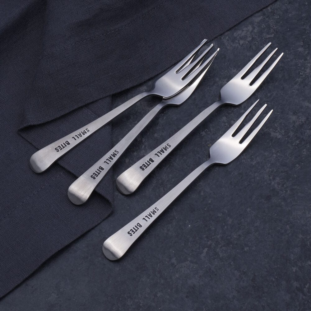 Elegant appetizer forks set of 4 on a dining table, perfect for dinner parties.