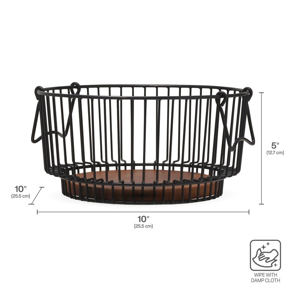 Side angle of the fruit basket placed on a kitchen island surrounded by fresh produce
