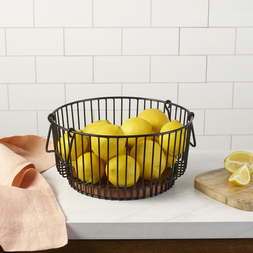 Top view of the wire fruit basket showing breathable design and mango wood base