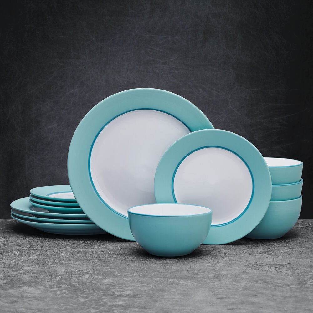 Grayson teal dinnerware set featuring dinner plates and bowls on a table setting.