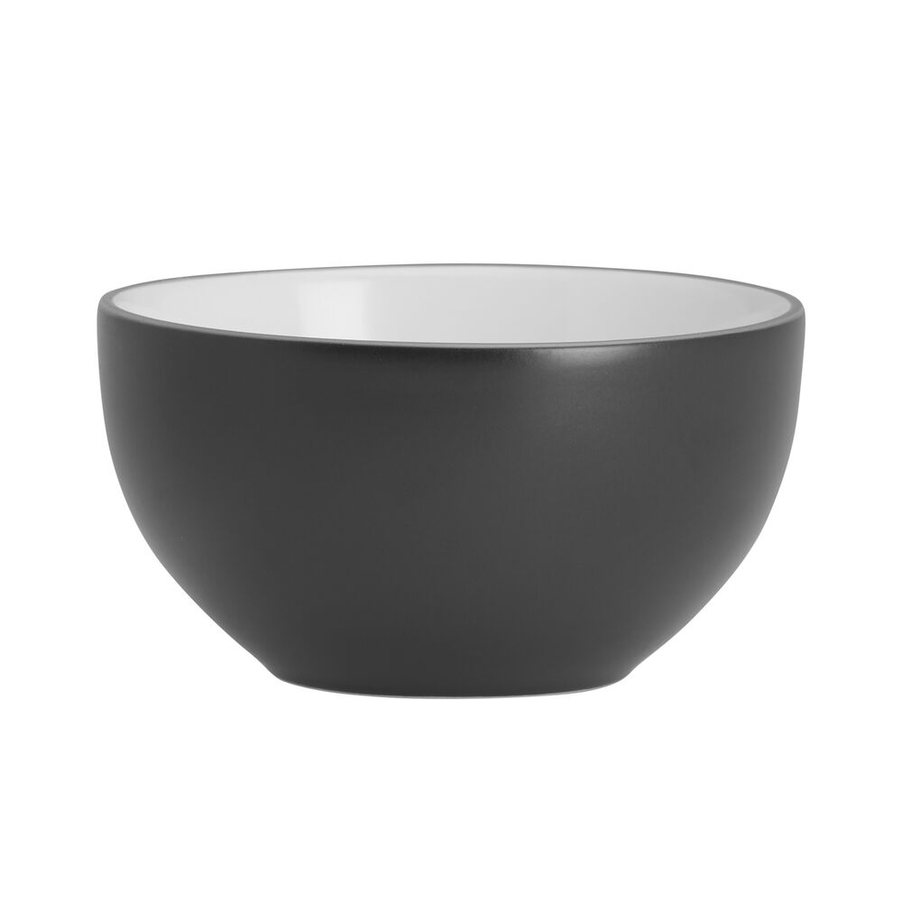 Set of four dinnerware plates, bowls, and salad plates on a modern table