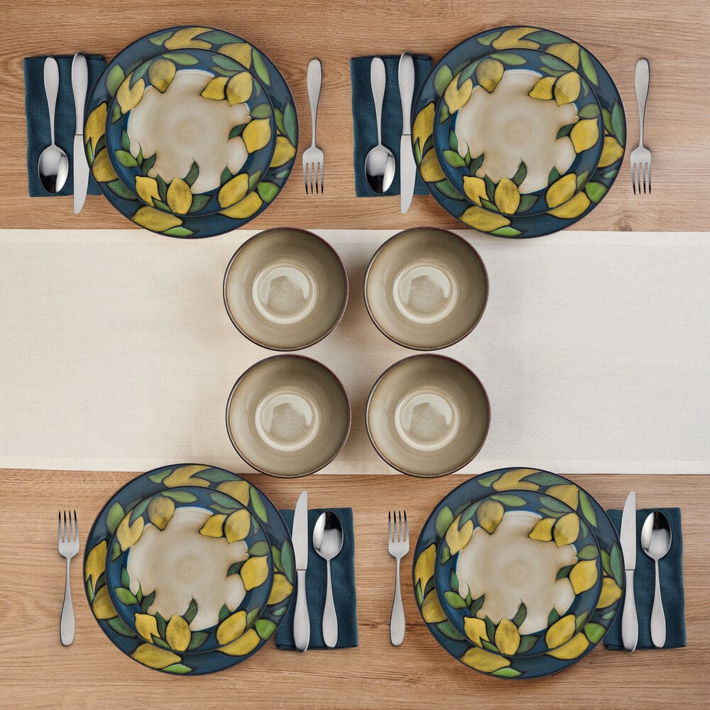 Set of stoneware dishes with vibrant lemon pattern on dining table