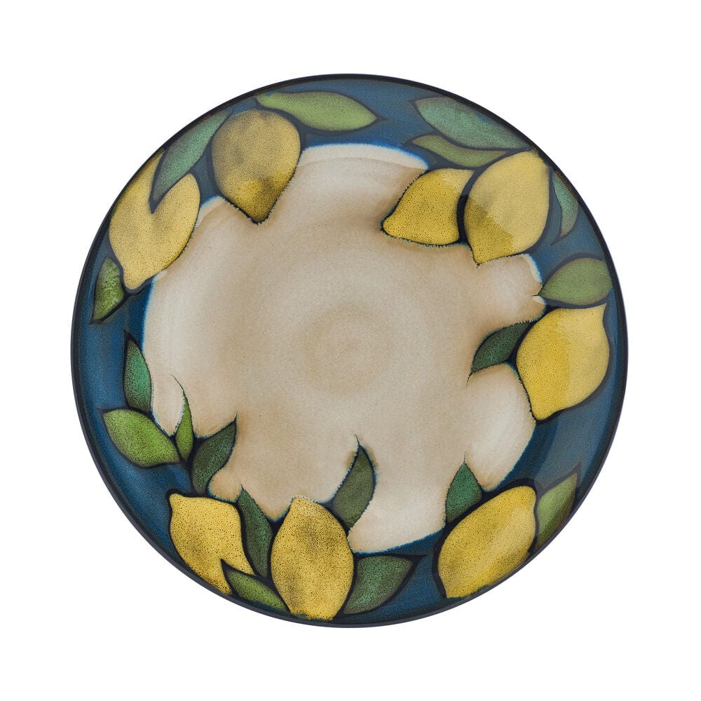 Set of stoneware dishes with vibrant lemon pattern on dining table