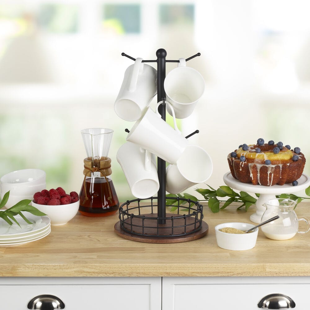 Elegant modern mug tree with wood base displayed on a kitchen counter, holding various mugs.
