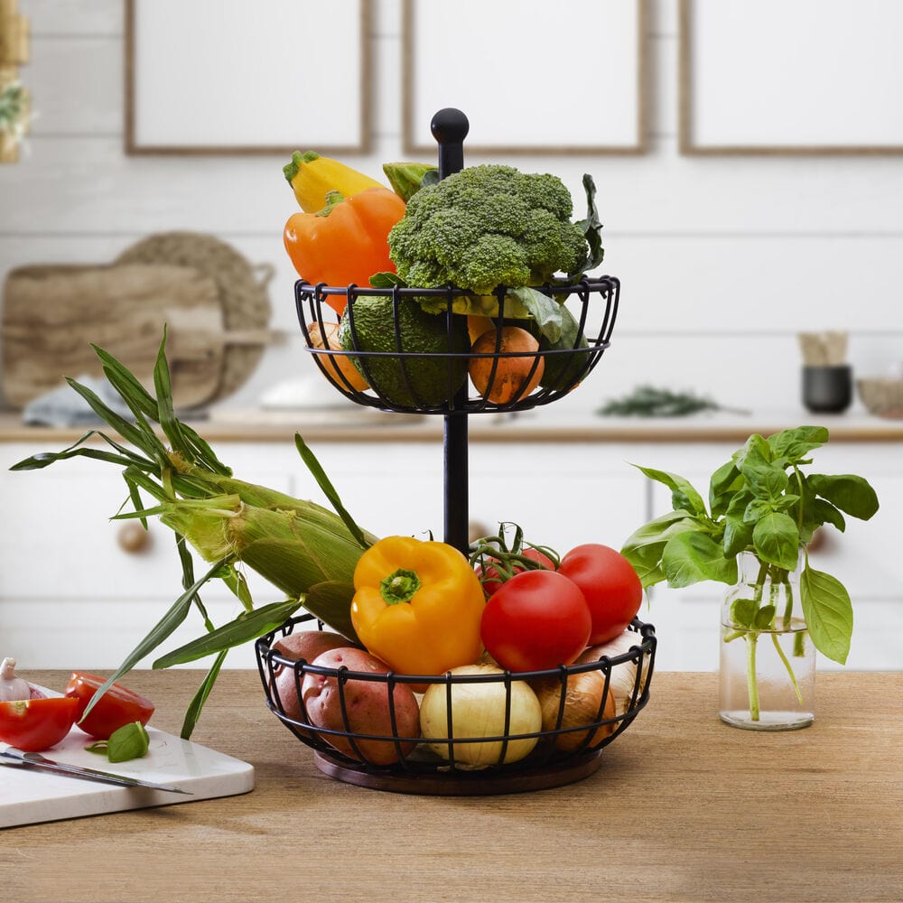 Elegant 2-tier wire storage basket showcasing fresh fruits on a kitchen countertop.