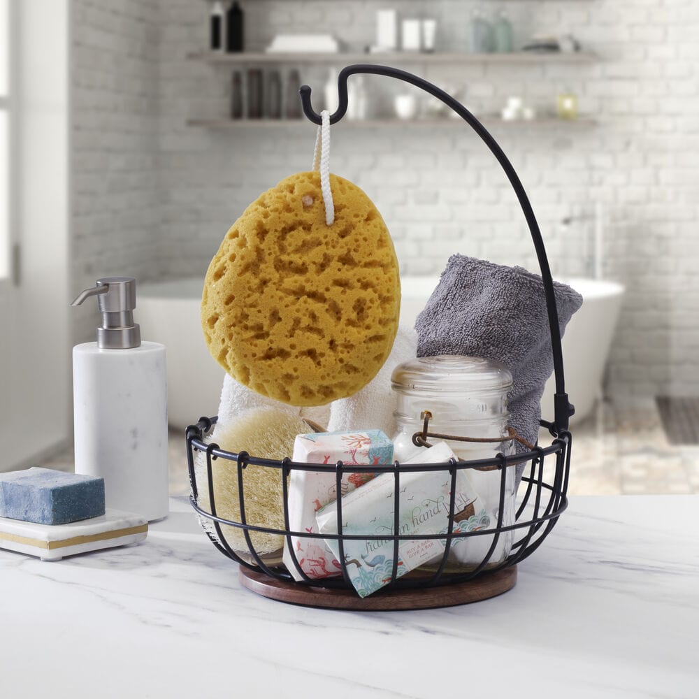Wire fruit basket with banana hook and wooden base on kitchen countertop