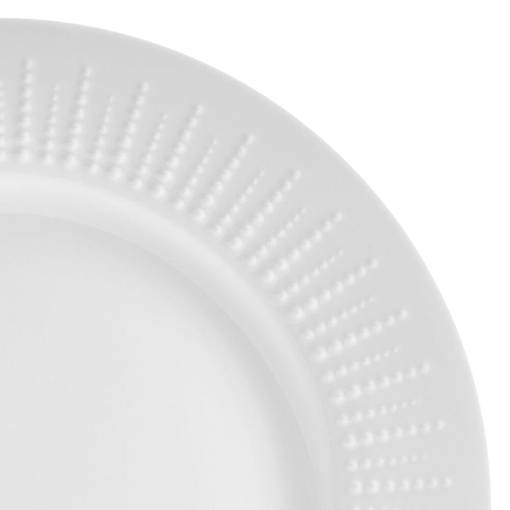 Close-up of embossed white porcelain dinnerware with beaded design