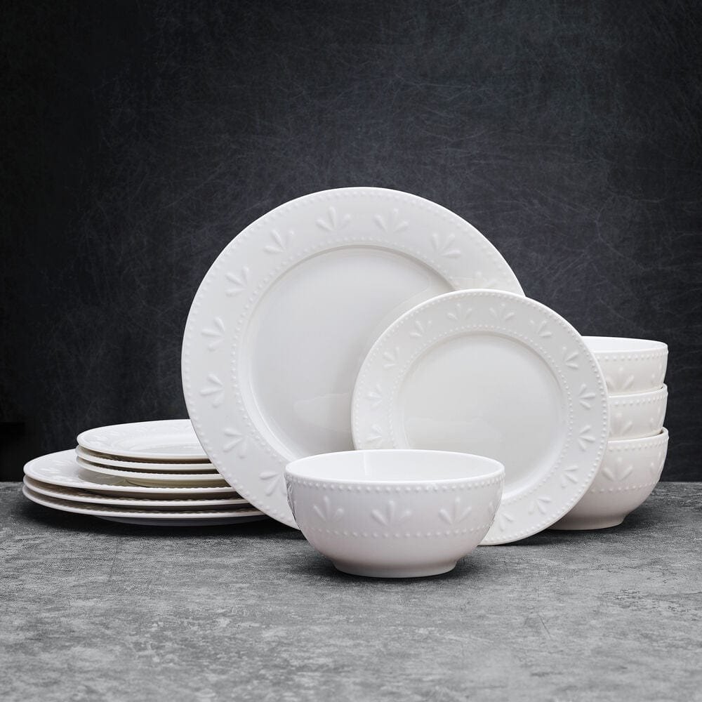 Close-up of embossed beaded rims on porcelain dinnerware set for four
