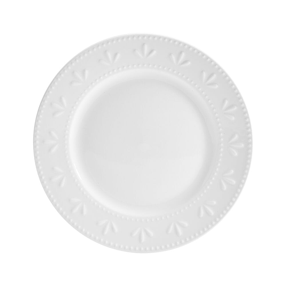 Dining table set with Maddy porcelain dinnerware, including plates and bowls with embossed design