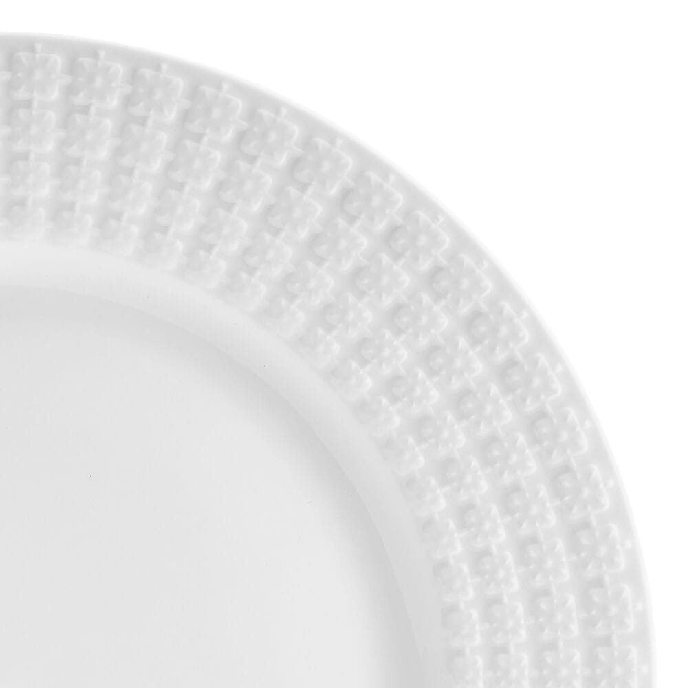 Square embossed white porcelain dinnerware set displayed on a dining table
