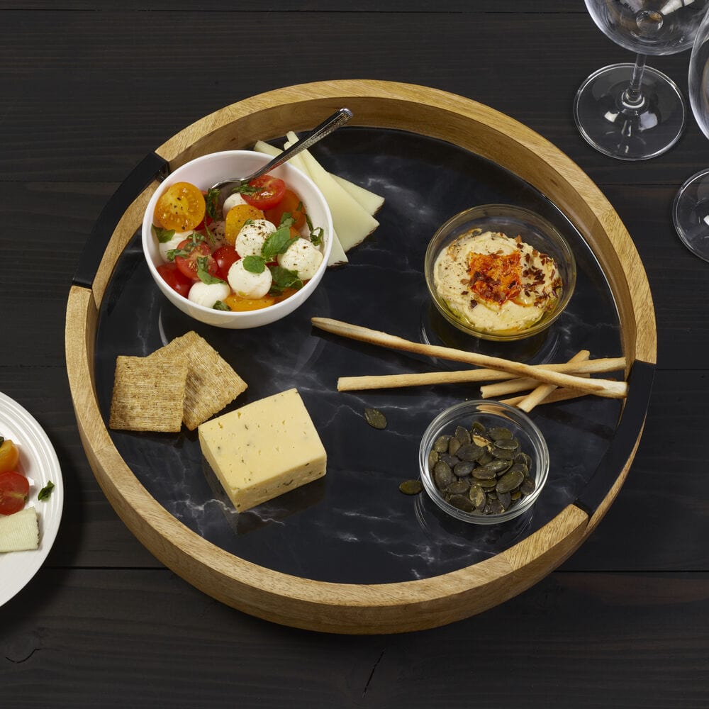 Close-up of black marble lazy susan showing its sleek surface and high wall for party serving