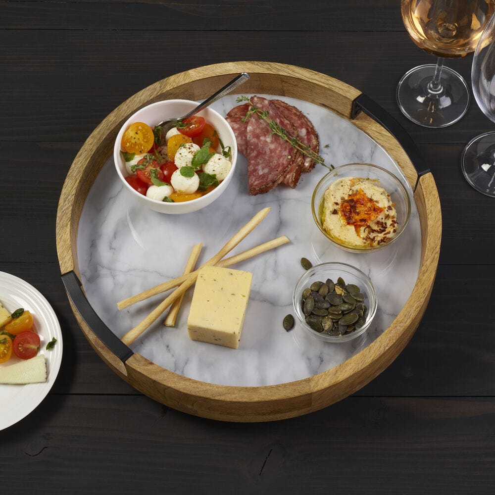Elegant gray marble lazy Susan serve tray showcasing appetizers and snacks.