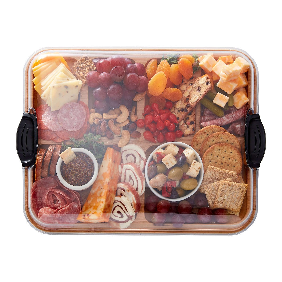 Close-up of compartments filled with cheese, fruits, and nuts on the charcuterie board