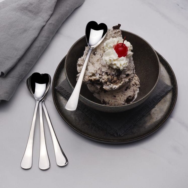 Heart-shaped ice cream spoon set beautifully displayed on a table.