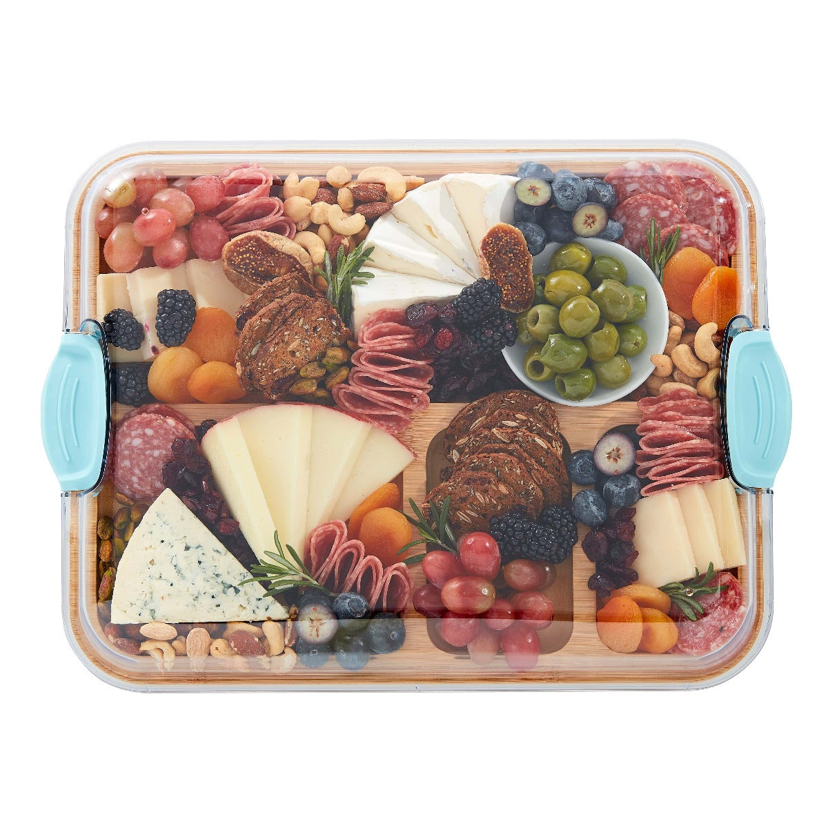 Close-up of compartments filled with cheese, fruits, and nuts on the charcuterie board
