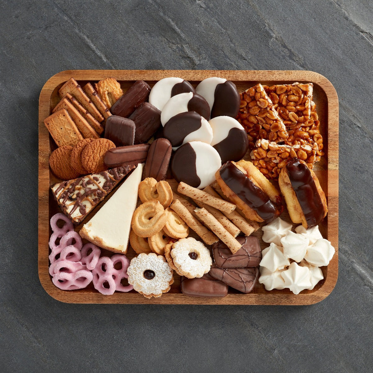Close-up of compartments filled with cheese, fruits, and nuts on the charcuterie board