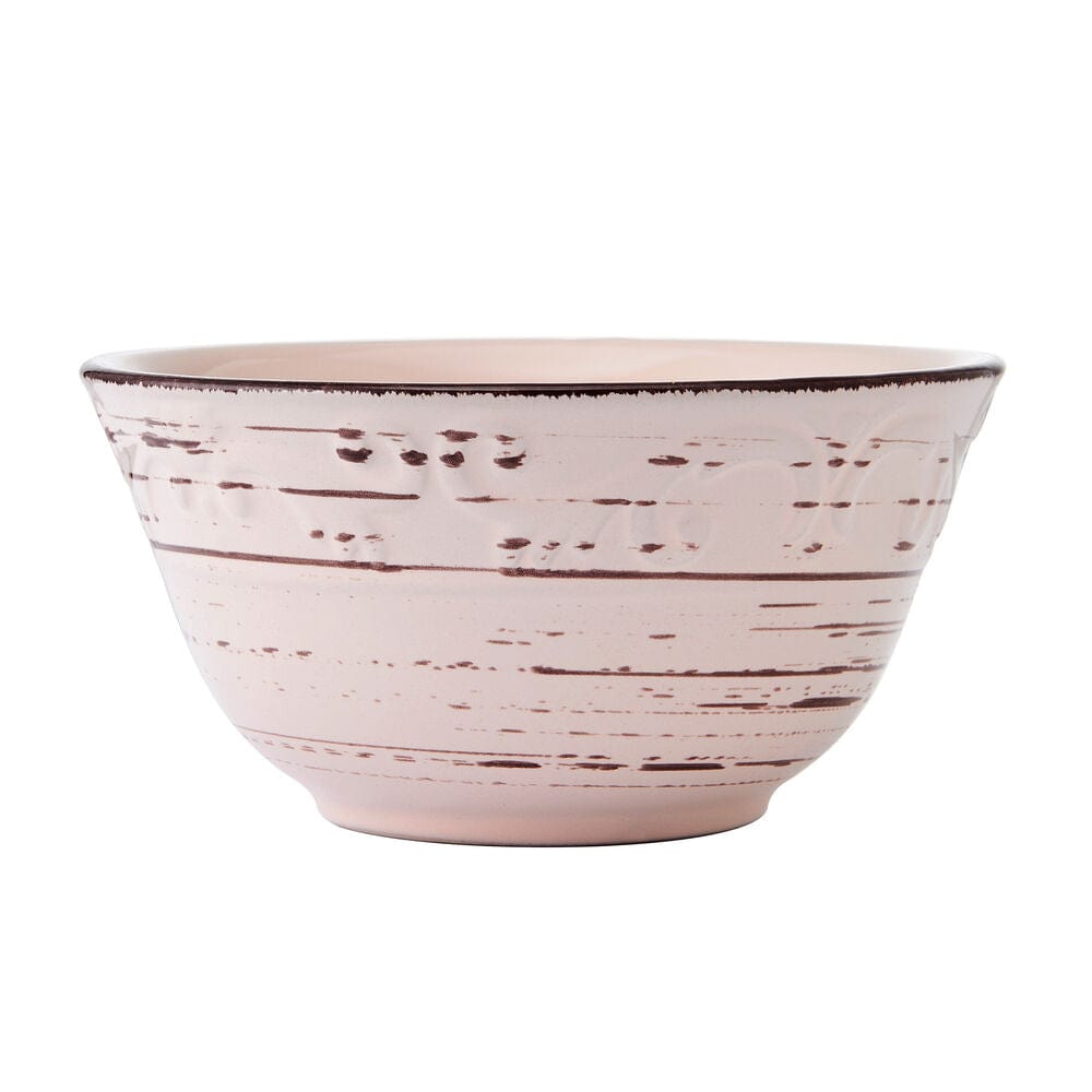 All-purpose bowl from the pink stoneware dinnerware set filled with fresh salad.