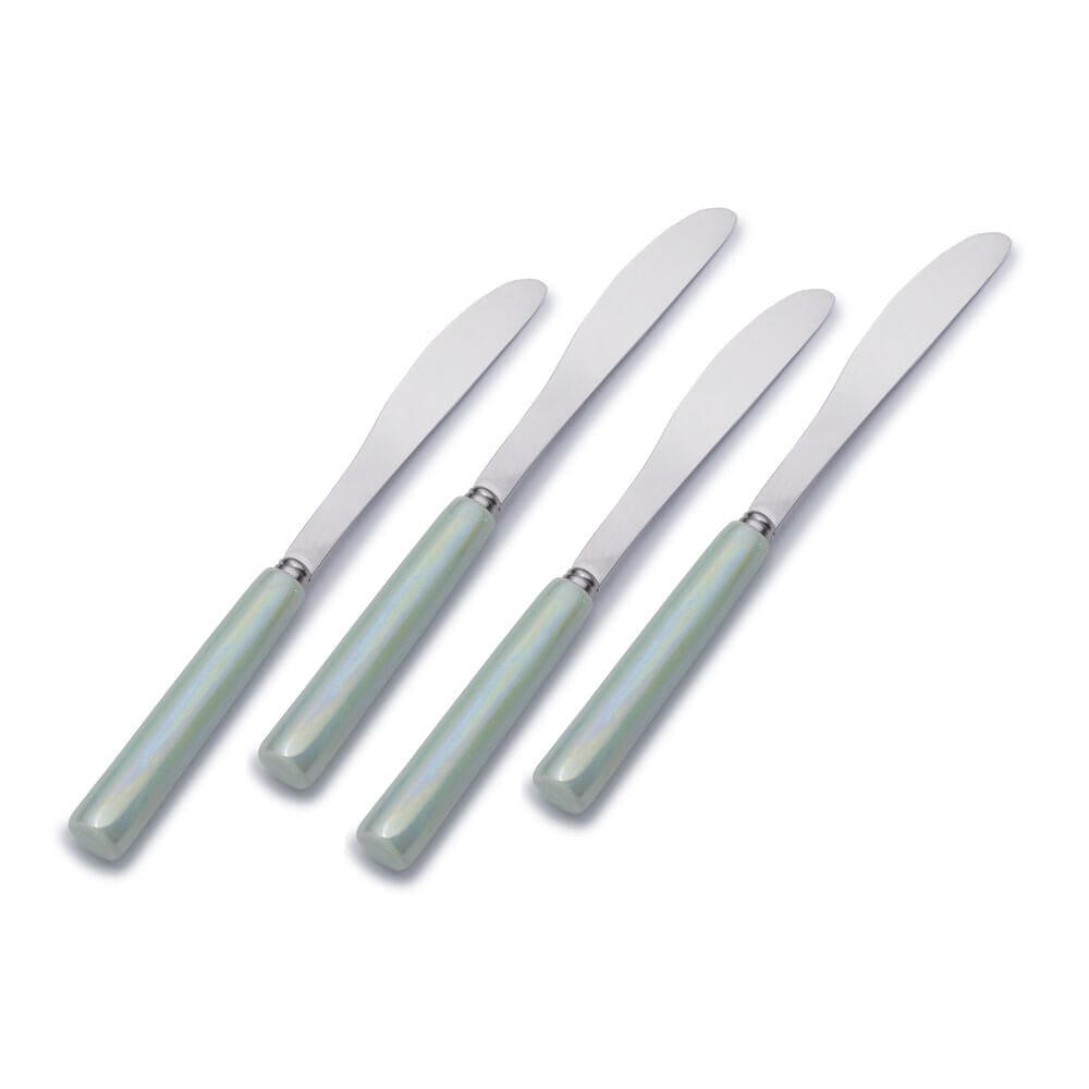 Set of four ceramic spreaders arranged for a dinner party
