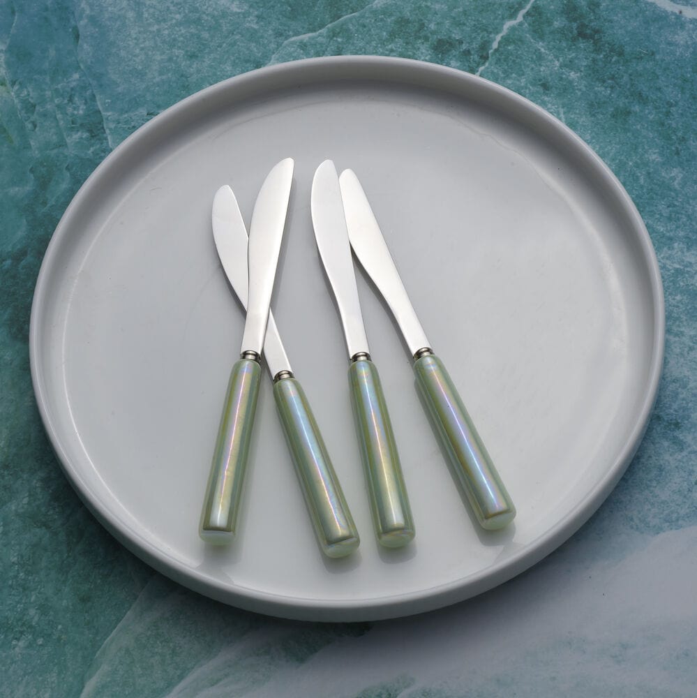 Elegant flatware spreaders displayed with appetizers
