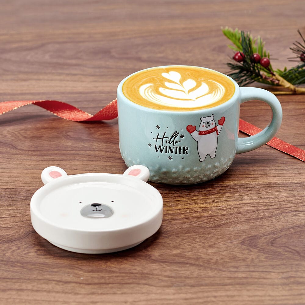 Charming polar bear coffee mug with lid, showing playful decal.