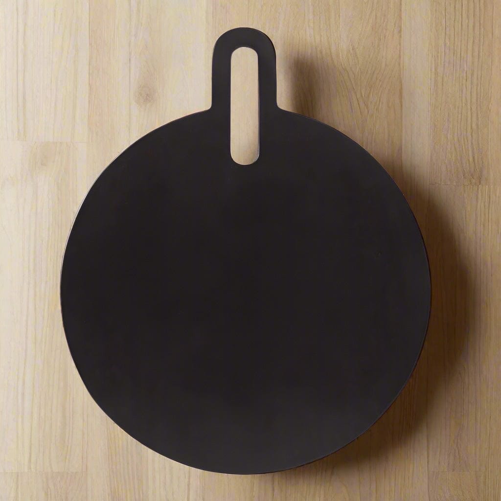 Close-up of mango wood round serve board with black finish showcasing cheese and fruits