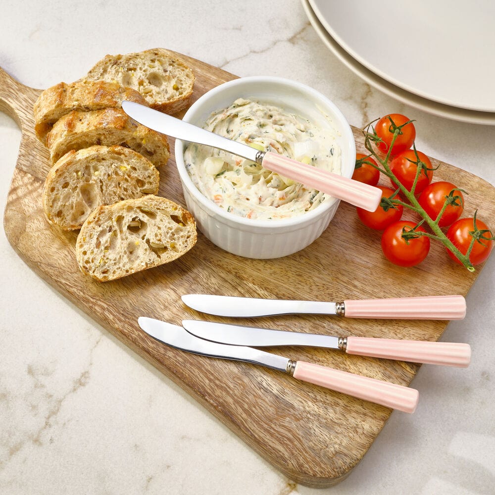 Set of four pink-handled kitchen spreaders for dinner parties