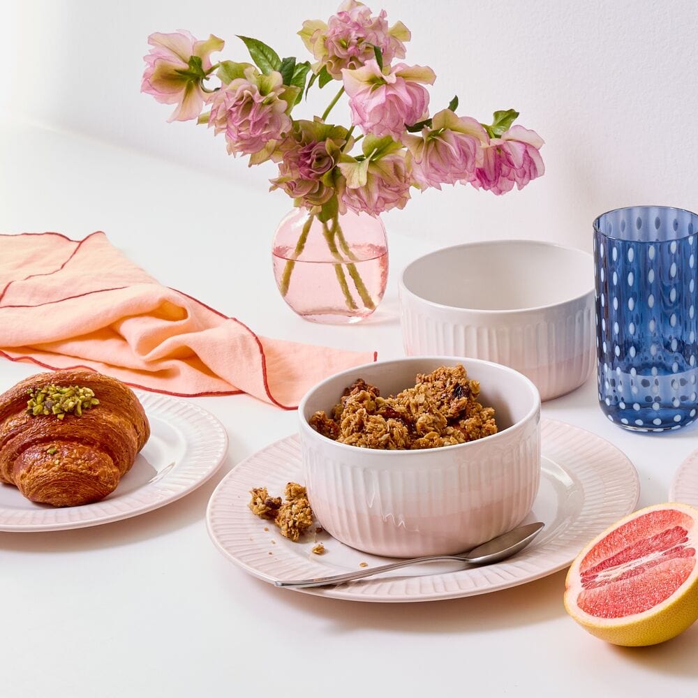Elegant blush dinnerware set on a modern table for special occasions
