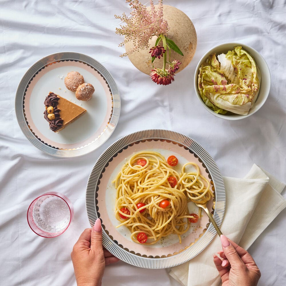 Close-up of gold and blush porcelain dinner plates with metallic rims