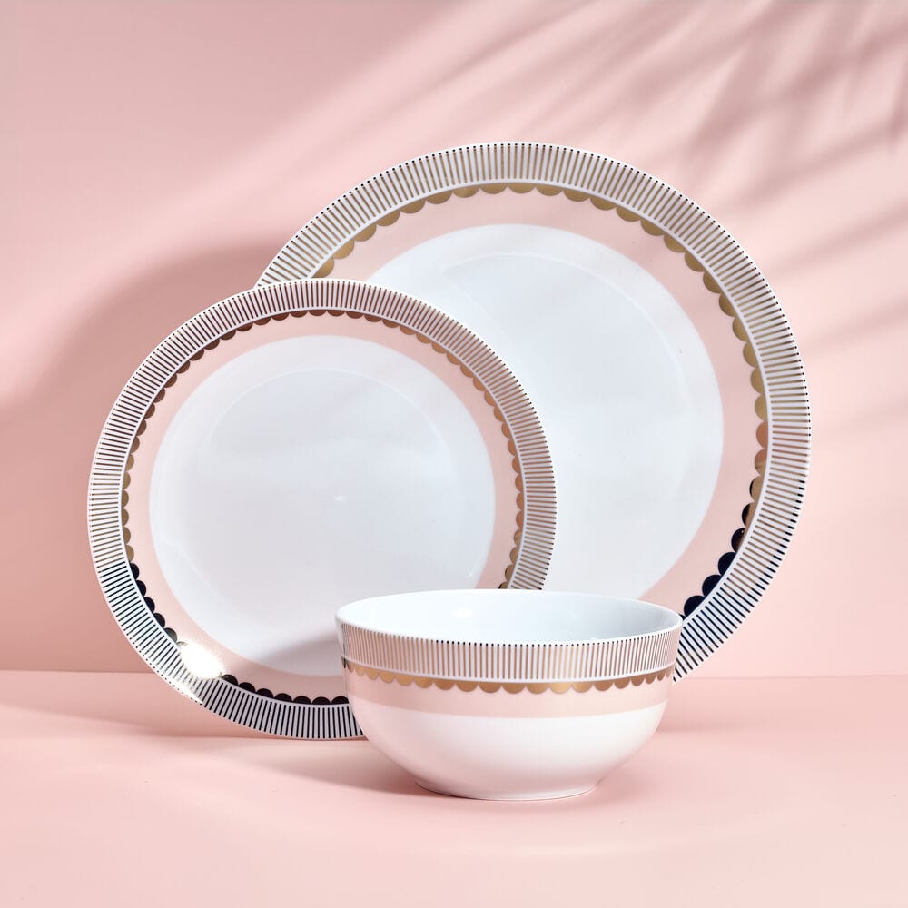 Close-up of gold and blush porcelain dinner plates with metallic rims