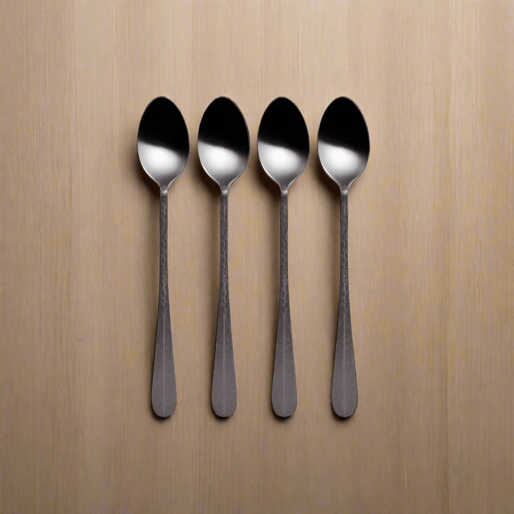 A close-up of Sable Black long handled spoon, highlighting its hammered texture.