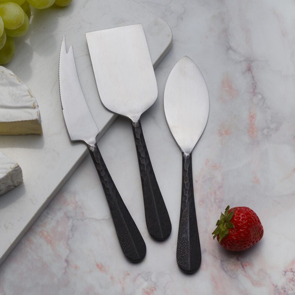 Sable Black cheese board with cheese knives displayed elegantly on a dining table.