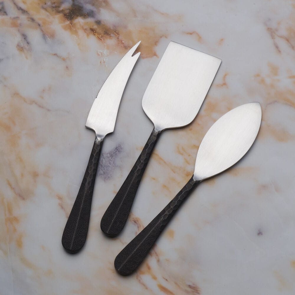 Sable Black cheese board with cheese knives displayed elegantly on a dining table.