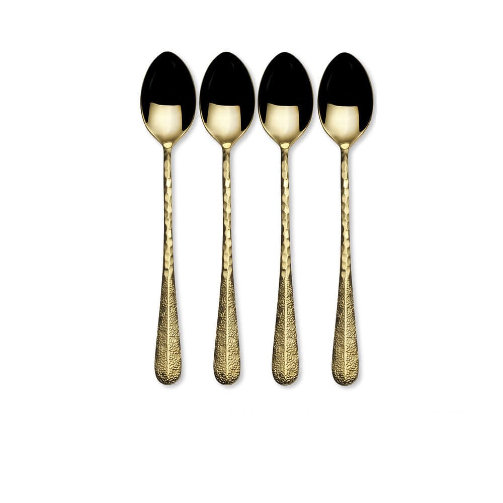 Long handled gold serving spoons arranged on a table setting