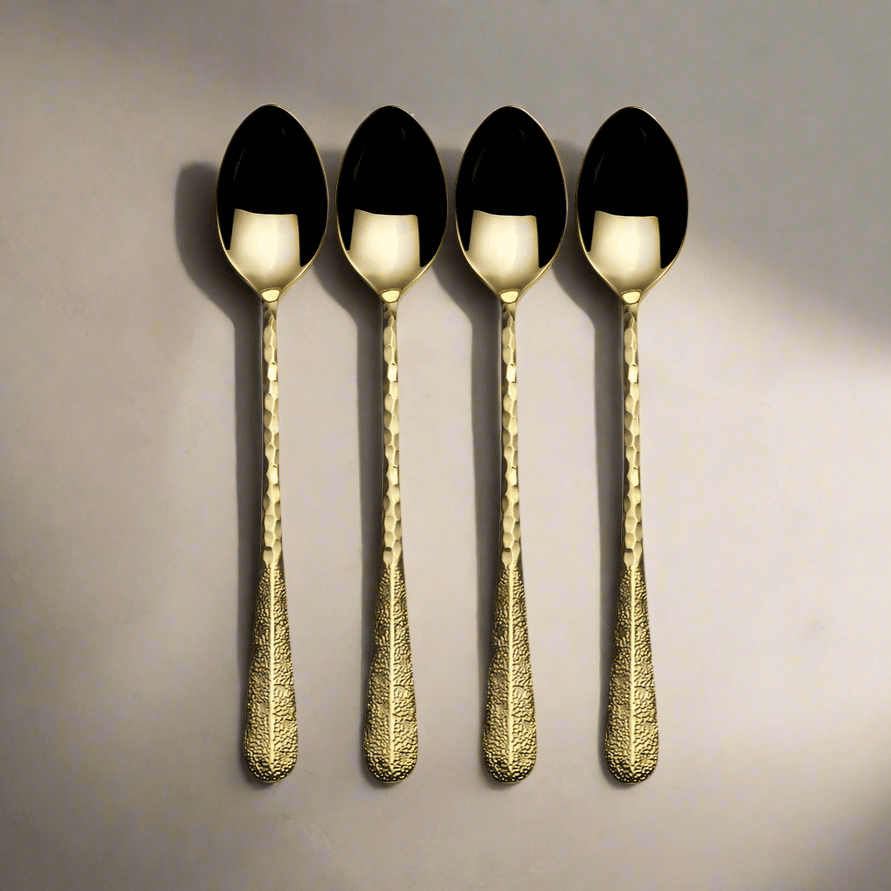Close-up of hammered finish on gold long handled serving spoon