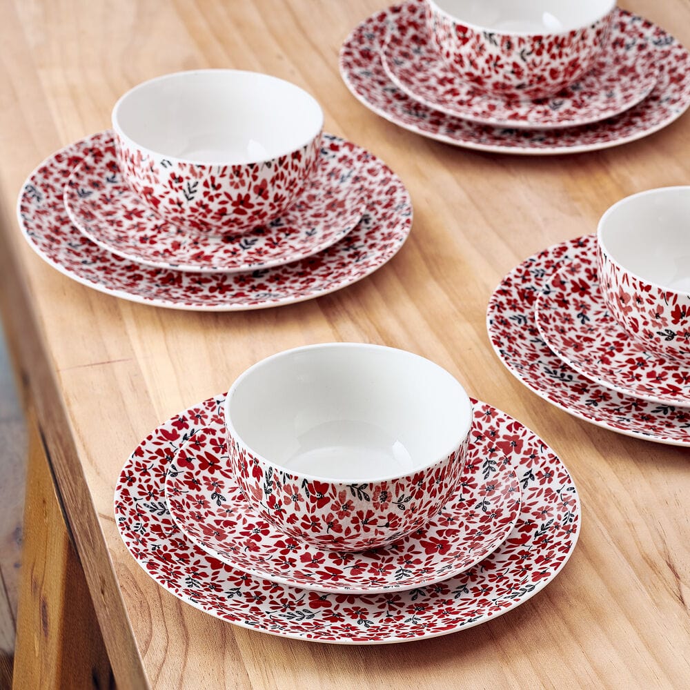 Close-up of colorful floral dinner plates with pink and red blossoms for family meals