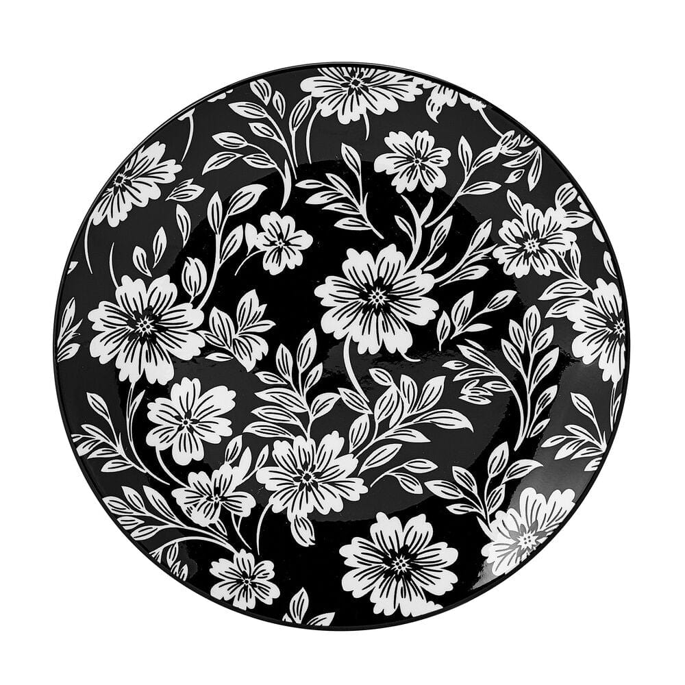 Close-up of Midnight Blooms floral dinnerware set on table, showcasing the bold black and white pattern