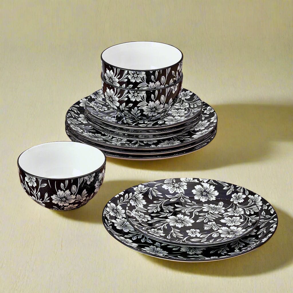 Close-up of Midnight Blooms floral dinnerware set on table, showcasing the bold black and white pattern