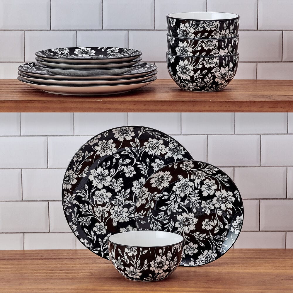 Close-up of Midnight Blooms floral dinnerware set on table, showcasing the bold black and white pattern