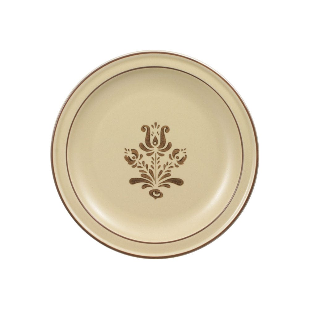 Close-up of rustic stoneware salad plate showcasing its texture and color.