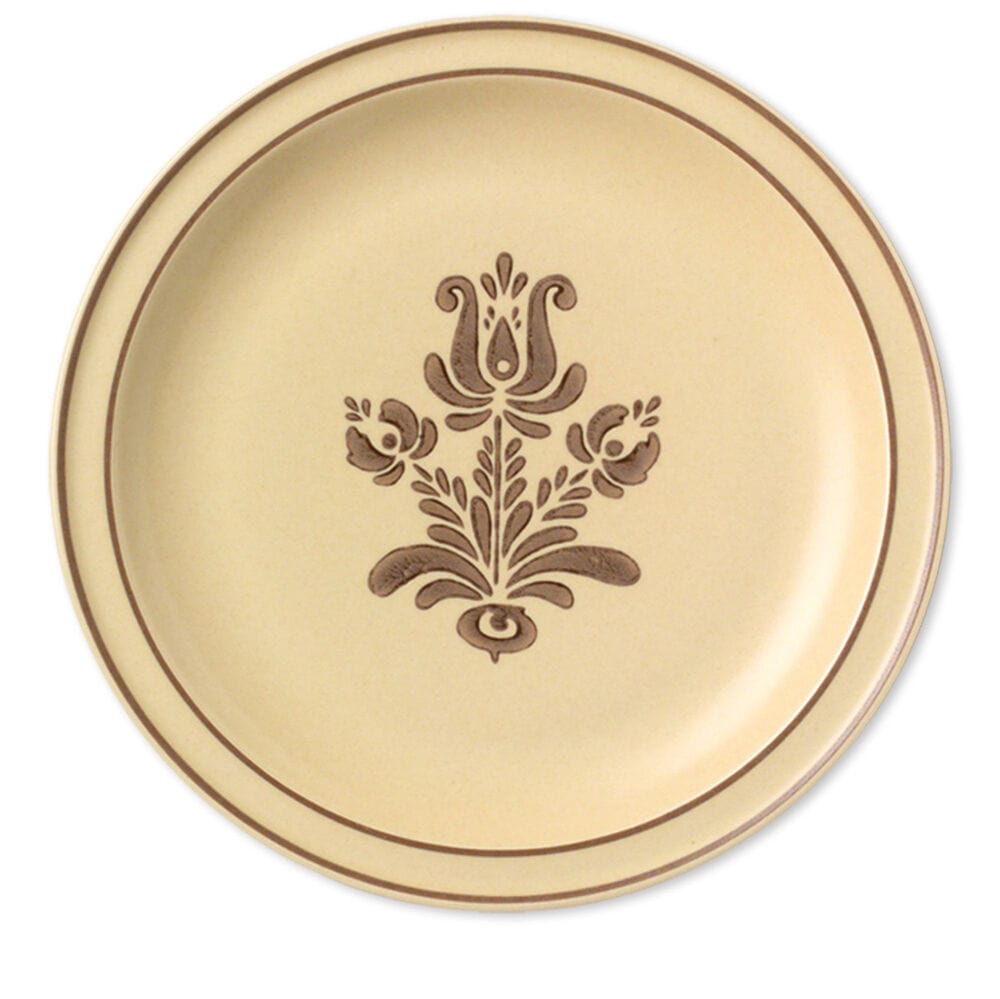 Large stoneware dinner plates stacked on a dining table, showcasing their durability and style