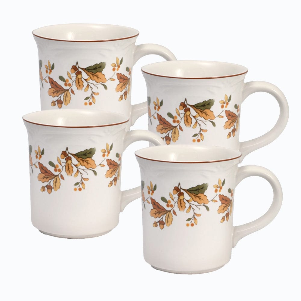 Set of four dishwasher safe tea mugs arranged on a cozy table