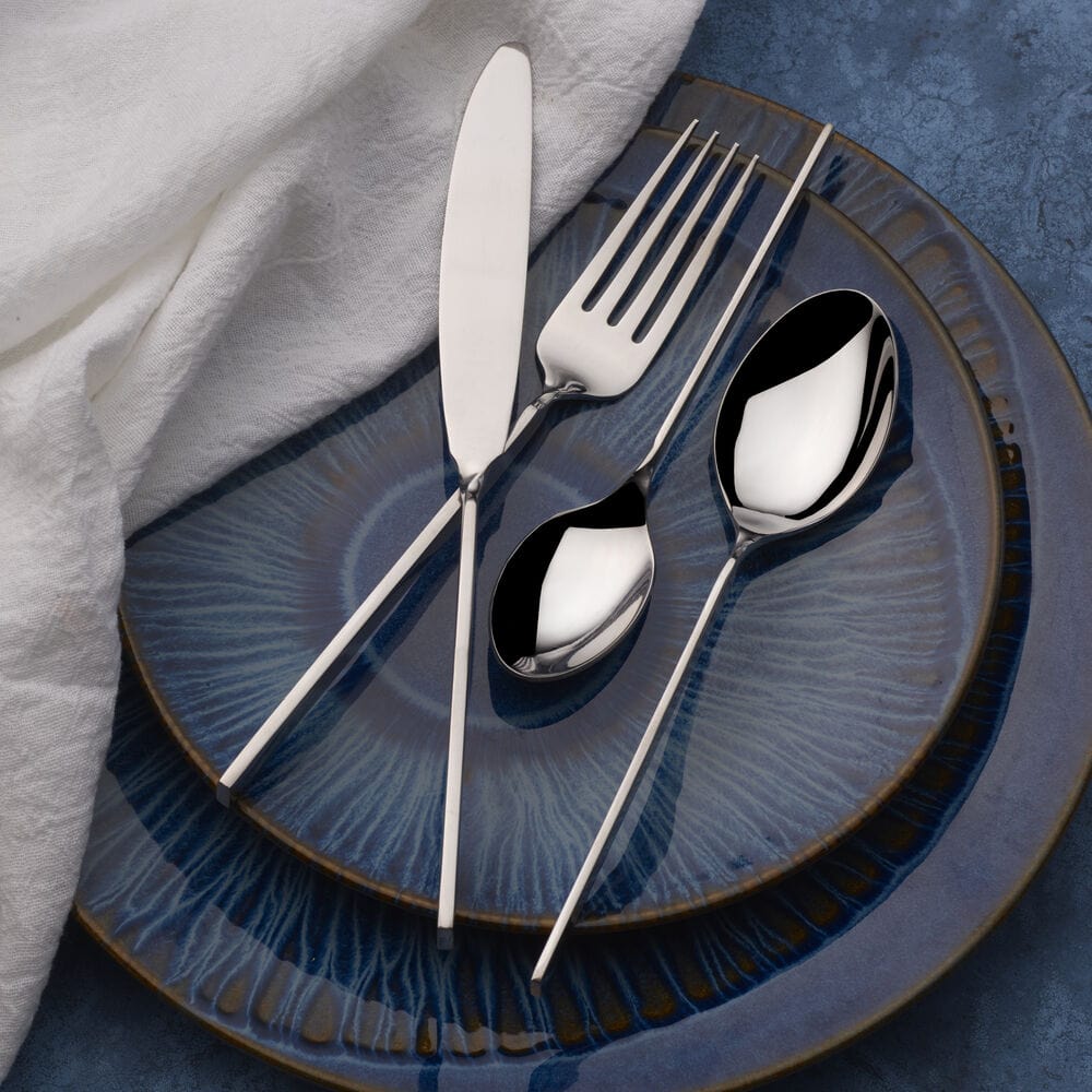 Dishwasher-safe stainless steel cutlery with polished finish on a kitchen countertop