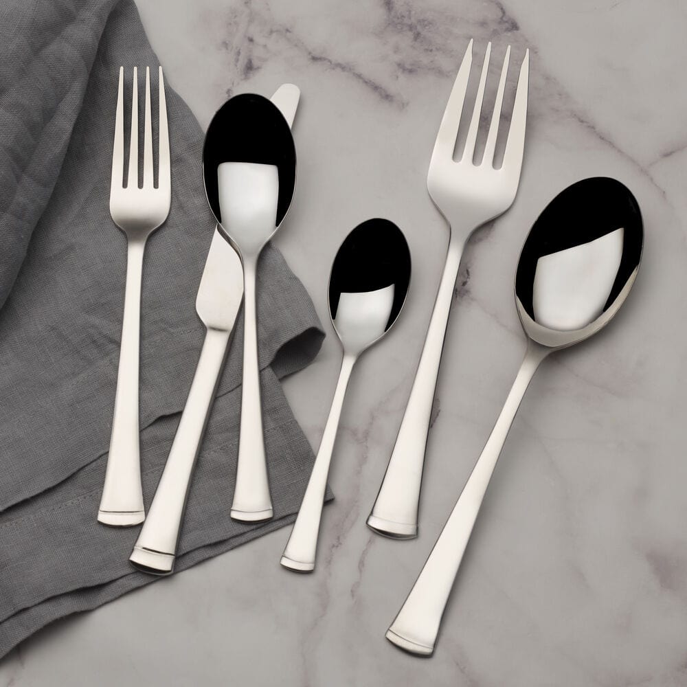 Elegant Conley flatware set displayed on a dining table for a dinner party.