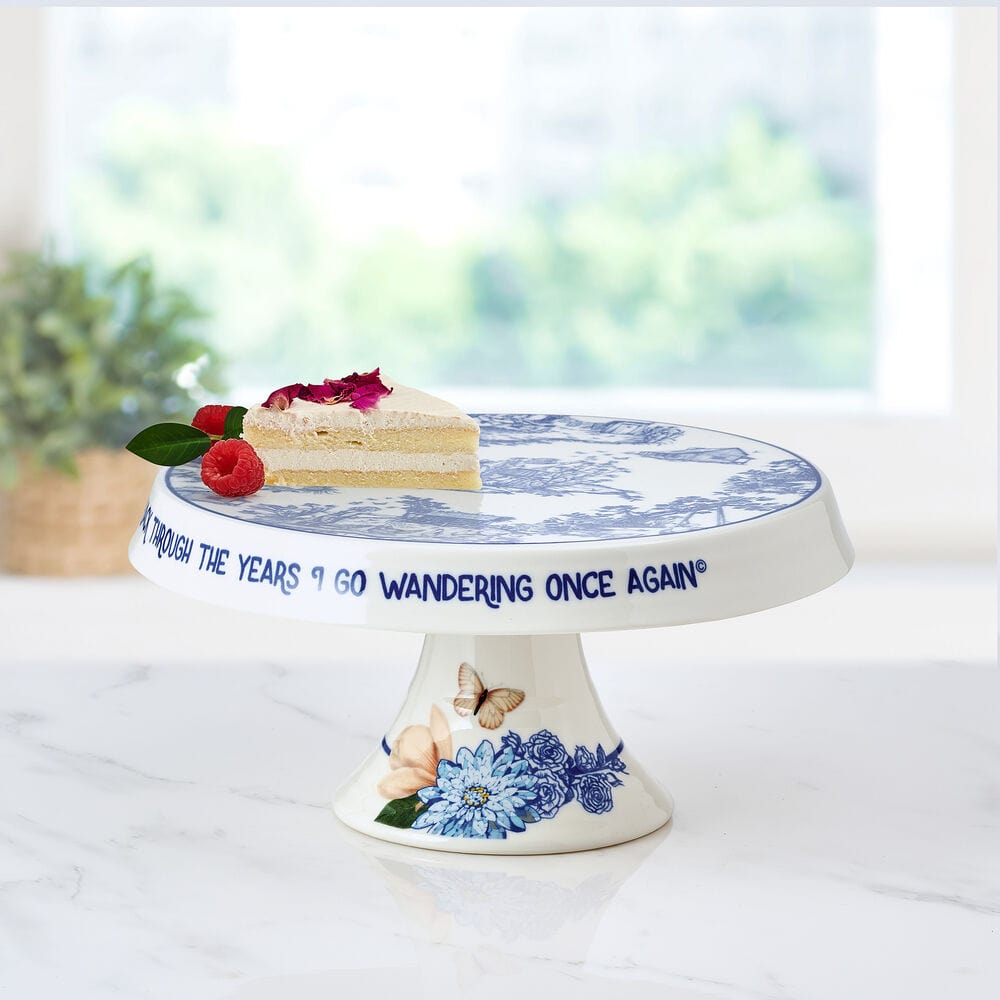 Dolly Parton cake stand displaying a colorful cake with musical notes in the background.