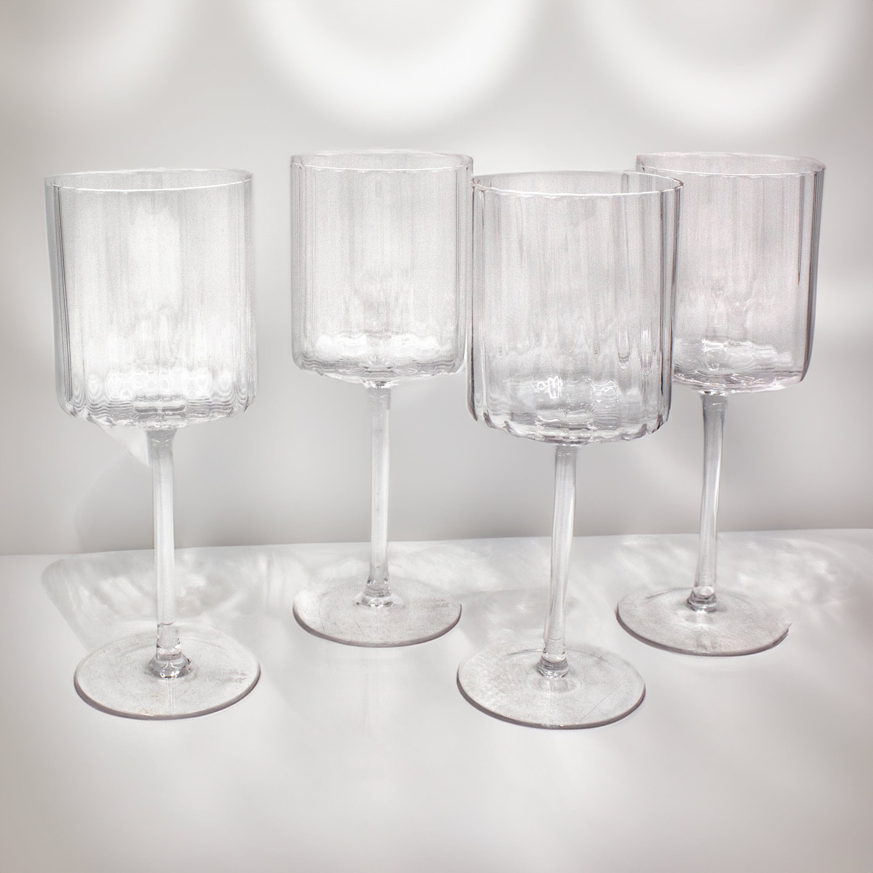 Set of 4 durable wine glasses showcasing prismatic design from multiple angles.