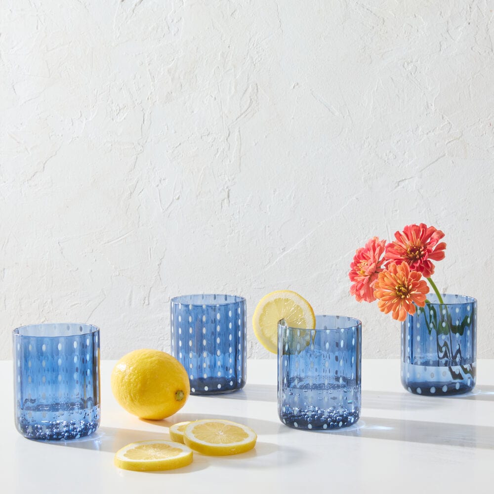 Cobalt double old fashioned glass set at a dinner table, showcasing its vibrant color and elegant design.
